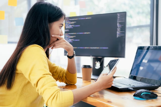 Female cybersecurity consultant analysing DSS compliance data on screen